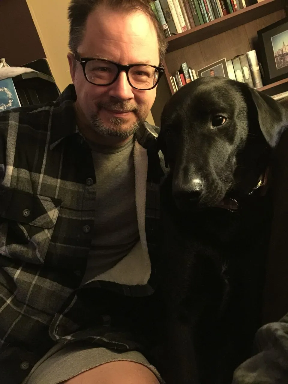 Jeff Oaks, whtie man with glasses and beard, and his dog Andy/Photo by Michael Rusnak