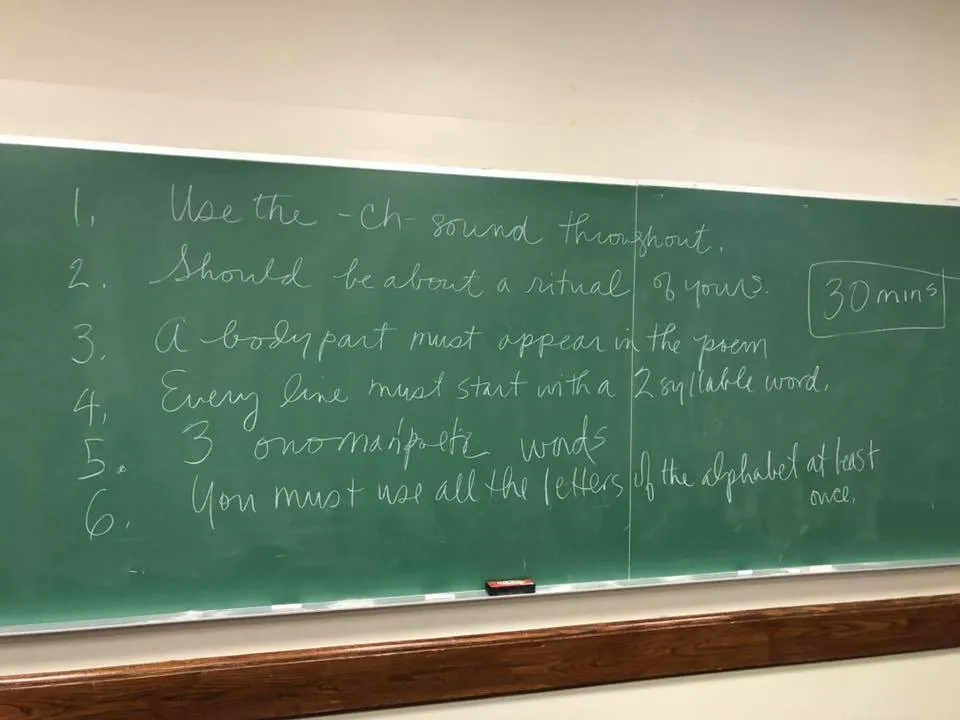 Chalkboard from Jeff Oaks' class with a list of requirements and restrictions in a writing prompt
