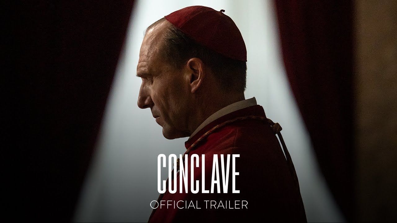 Title frame of the trailer for Conclave show film name and Ray Fiennes as a cardinal who must manage the gathering to select a new pope.