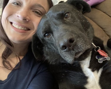 Briana Wipf Headshot with Black Dog