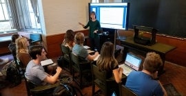 Teacher standing in front of a classroom with students